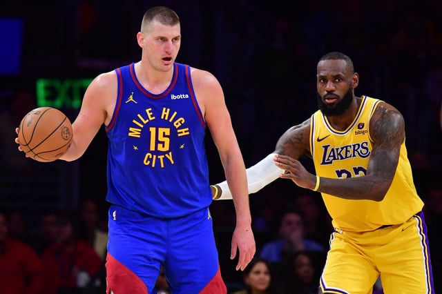 Apr 25, 2024; Los Angeles, California, USA; Denver Nuggets center Nikola Jokic (15) controls the ball against Los Angeles Lakers forward LeBron James (23)  during the second half in game three of the first round for the 2024 NBA playoffs at Crypto.com Arena. Mandatory Credit: Gary A. Vasquez-USA TODAY Sports/File Photo
