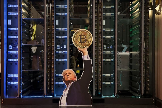 A cutout of President Donald Trump holding a Bitcoin is displayed on a group of servers during The Bitcoin Conference at The Venetian in Las Vegas on May 27, 2025. (Photo by IAN MAULE/AFP via Getty Images)