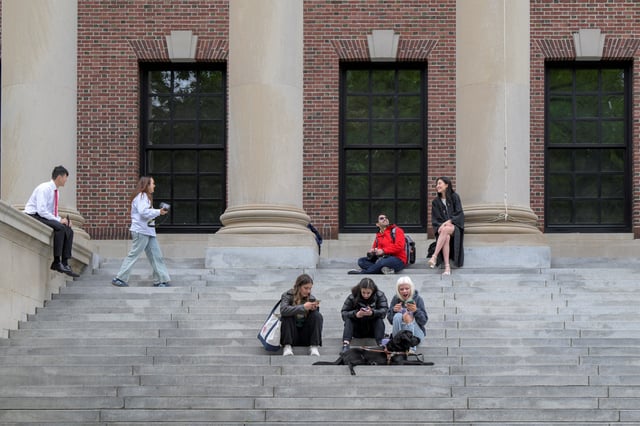 Students gather on the campus of Harvard University in Cambridge, Massachusetts, U.S., May 23, 2025. REUTERS/Faith Ninivaggi/File Photo