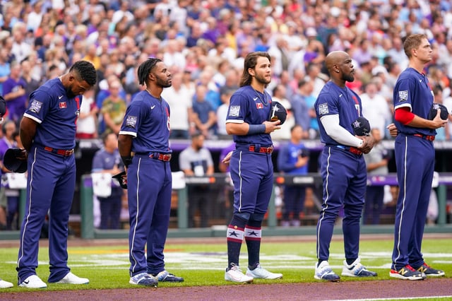 Players of the American League team stand for the national anthem during the 91st MLB All-Star Game presented by Mastercard at Coors Field on July 13, 2021 in Denver, Colorado.