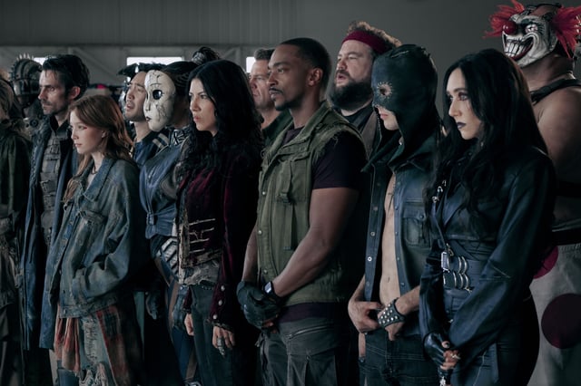TWISTED METAL -- Pictured: (l-r) Richard De Klerk as Mr. Grimm, Saylor Bell Curda as Mayhem, Andre De Kim as Chuckie Floop, Tiana Okoye as Dollface, Stephanie Beatriz as Quiet, Johnno Wilson as Dave, Anthony Mackie as John Doe, Mike Mitchell as Stu, Tyler Johnston as Deacon, Patty Guggenheim as Raven, Joe Seanoa as Sweet Tooth— (Photo by: Pief Weyman/PEACOCK)