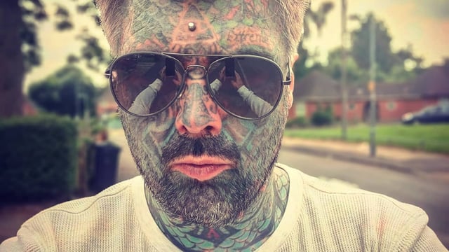 most tattooed man in uk holding phone