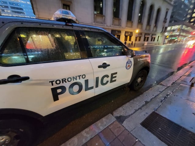 A Toronto police vehicle is shown parked on Yonge Street near King Street as rain falls in downtown Toronto on Tuesday Jan. 3, 2023. 