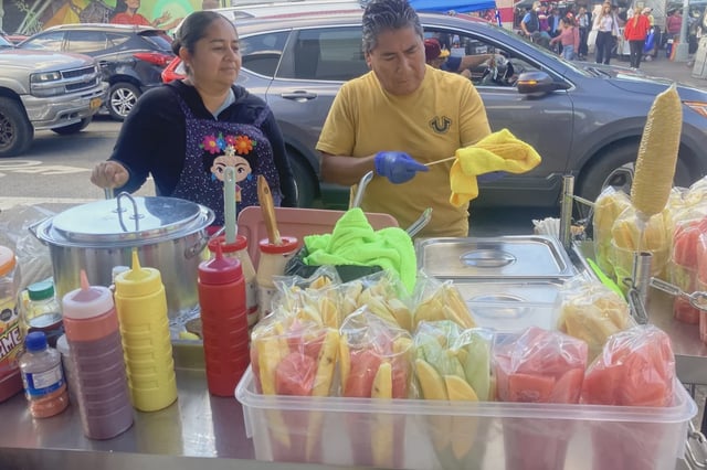 Street vendors Ruth Palacios, 43, and  her husband, Auturo Xelo, 60, sell their wares on a busy street corner abutting Junction Boulevard in Corona, Queens.