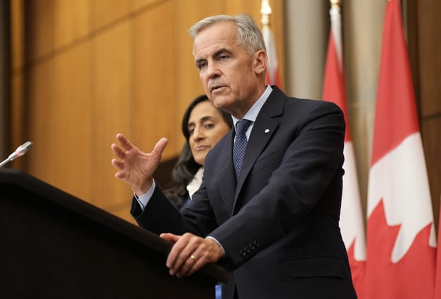 Prime Minister Mark Carney (alongside Foreign Affairs Minister Anita Anand) speaks with media during a news conference in Ottawa, Wednesday, July 30, 2025. THE CANADIAN PRESS/Adrian Wyld