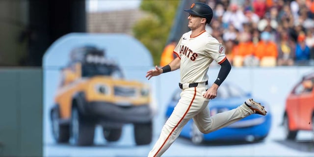 Jul 27, 2025; San Francisco, California, USA; San Francisco Giants outfielder Mike Yastrzemski (5) advances to third on a base hit by first baseman Dominic Smith (7) during the second inning against the New York Mets at Oracle Park. Mandatory Credit: Bob Kupbens-Imagn Images.