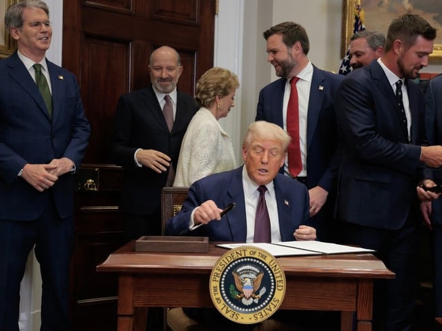 U.S. President Donald Trump signs an executive order in the Roosevelt Room of the White House on July 31, 2025, in Washington, D.C.