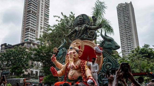 Devotees carry an idol of the elephant-headed Hindu deity 'Ganesha' ahead of the Ganesh Chaturthi festival in Mumbai on July 20, 2025. (Photo by Punit PARANJPE / AFP) (AFP)