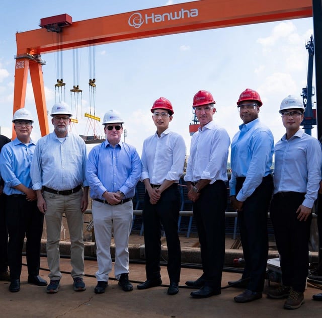 This photo, taken July 30, 2025, and provided by Hanwha Ocean Co., shows White House budget official Russell Vought (2nd from L), U.S. Secretary of the Navy John Phelan (3rd from L), and Hanwha Group Vice Chairman Kim Dong-kwan (C) posing for a photo during their visit to Hanwha Philly Shipyard in Philadelphia. (PHOTO NOT FOR SALE) (Yonhap)