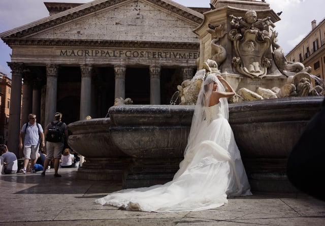 FILE - A bride poses for photos in front of Rome's Pantheon, June 28, 2013. (AP Photo/ Domenico Stinellis, File)