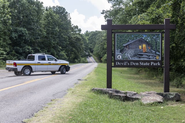 An Arkansas Park Ranger patrols the South Entrance of Devils Den State Park Monday, July 28, 2025, in West Fork, Ark. Police in Arkansas are searching for a suspect in the deaths of a couple who investigators said were attacked while on a wooded walking trail with their two young daughters. (AP Photo/Michael Woods)