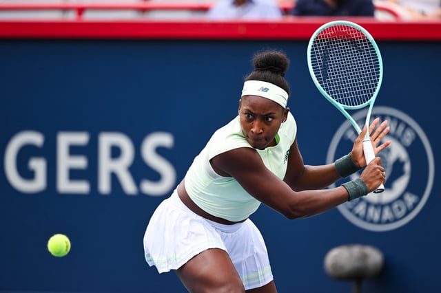 Jul 31, 2025; Montreal, QC, Canada; Coco Gauff (USA) returns the ball to Veronika Kudermetova in third round play at IGA Stadium. Mandatory Credit: David Kirouac-Imagn Images