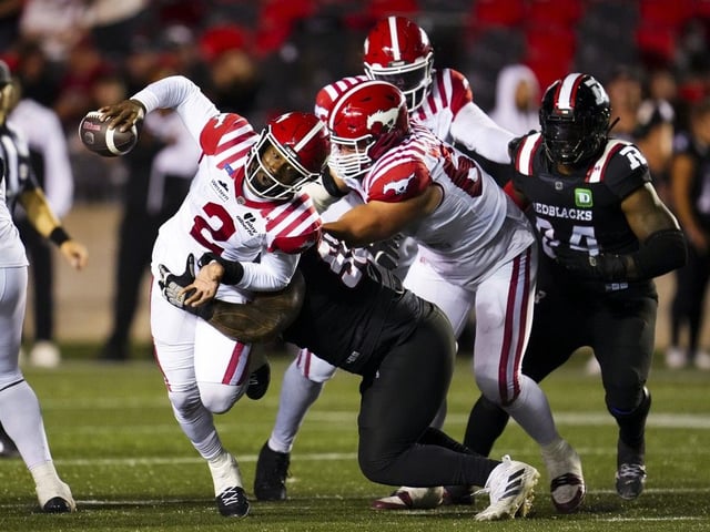 Calgary Stampeders quarterback P.J. Walker (2) gets sacked by Ottawa Redblacks defensive lineman Blessman Ta'ala (55) during second half CFL football action in Ottawa on Thursday, July 31, 2025.
