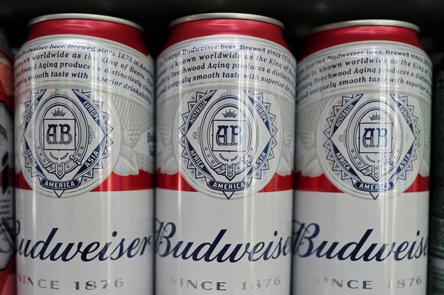 Cans of Budweiser beer are displayed on a supermarket shelf in Shanghai, China February 24, 2022. REUTERS/Aly Song/ File Photo