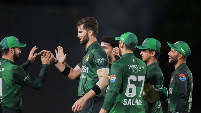 Shaheen Afridi celebrates a wicket alongside Salman Ali Agha and other teammates.