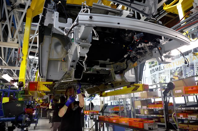 Employees work on the automobile assembly line of Renault Trafic vehicles at the Renault Sandouville car factory, near Le Havre, France, March 29, 2024. REUTERS/Sarah Meyssonnier/File Photo