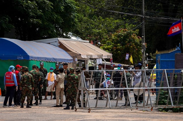 Two Cambodian soldiers (white shirts) who were detained in Thailand, are released from captivity, at O Smach town located near Thailand and Cambodia's border, following a ceasefire between Cambodia and Thailand, Cambodia, August 1, 2025. REUTERS/Soveit Yarn