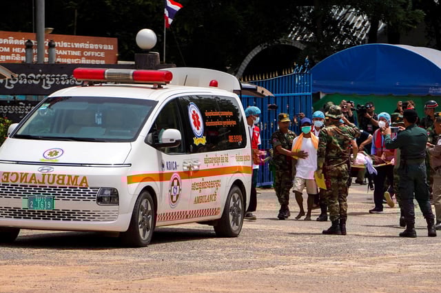 Two Cambodian soldiers (white shirts) who were detained in Thailand, are released from captivity, at O Smach town located near Thailand and Cambodia's border, following a ceasefire between Cambodia and Thailand, Cambodia, August 1, 2025. REUTERS/Soveit Yarn