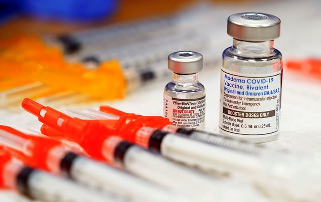 FILE - Pfizer, left, and Moderna bivalent COVID-19 vaccines are readied for use at a clinic, Nov. 17, 2022, in Richmond, Va. The Food and Drug Administration on Friday, June 16, 2023, told COVID-19 vaccine makers to update fall shots to target the latest omicron strain. (AP Photo/Steve Helber, File)
