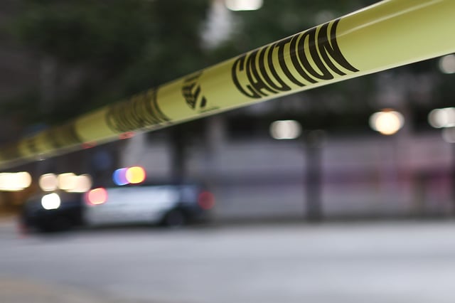 Flashing lights from a police vehicle parked behind yellow police tape on Thursday, July 11, 2024, in Houston.