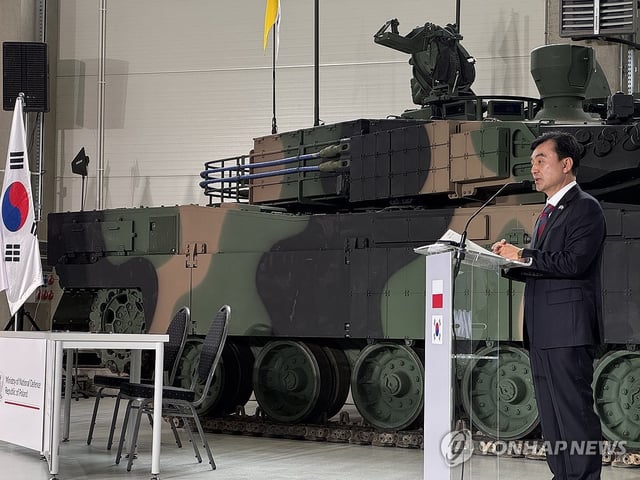 This photo, provided by Hyundai Rotem, shows Defense Minister Ahn Gyu-back speaking during a contract signing ceremony to supply additional K2 tanks to Poland in Gliwice, southern Poland, on Aug. 1, 2025. (PHOTO NOT FOR SALE) (Yonhap)