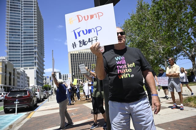 People protest against the policies of President Donald Trump and Elon Musk during a 50501 rally, Saturday, April, 19, 2025, in Orlando, Fla.