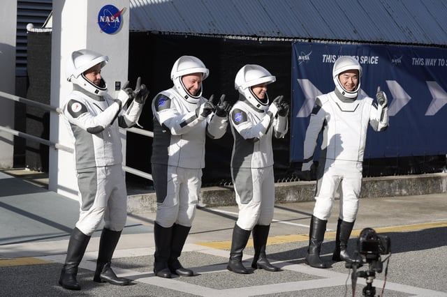 Astronauts, from left, Oleg Platonov, of Russia, Mike Fincke, Zena Cardman, and Kimiya Yui, of Japan react as they leave the Operations and Checkout Building for a trip the Kennedy Space Center's Launch Pad 39-A and a planned liftoff on a SpaceX Falcon 9 rocket Friday, Aug. 1, 2025, in Cape Canaveral , Fla. (AP Photo/John Raoux)