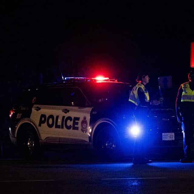 Ottawa Police Service officers block off a section of a residential street following an airplane crash near Ottawa International Airport in Ottawa, on Thursday, July 31, 2025. THE CANADIAN PRESS/Spencer Colby
