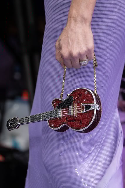 The miniature guitar purse, by Judith Leiber, was another nod to the inspiration outfit.