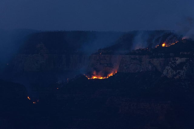Smoke and flames from the Dragon Bravo Fire are seen at sunset at the Grand Canyon in Arizona on Monday, July 28.