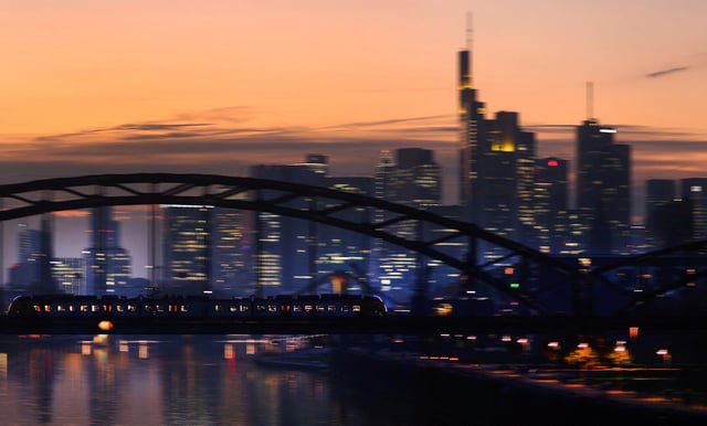 A commuter train passes by the skyline with its financial district ahead of the European Central Bank?s (ECB)  governing council meeting later this week in Frankfurt, Germany, October 25, 2021.  REUTERS/Kai Pfaffenbach/File Photo