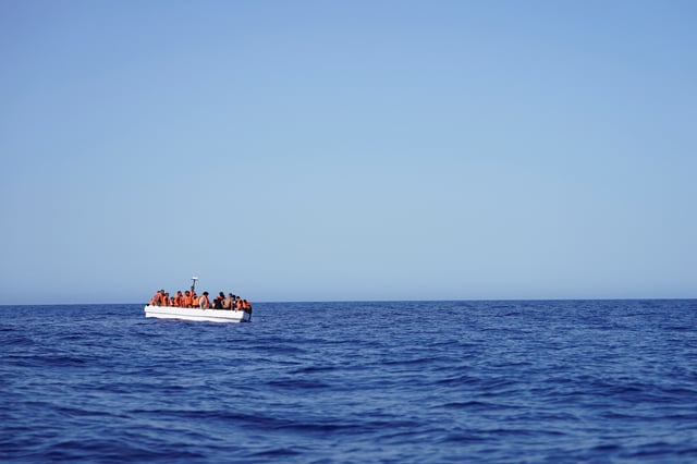 Migrants on a fiberglass boat wait to be assisted by NGO Open Arms rescue boat "Astral" in international waters south of Lampedusa, in the Mediterranean Sea, July 24, 2025. REUTERS/Ana Beltran/File Photo