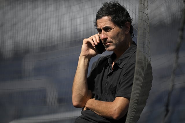SAN DIEGO, CALIFORNIA - JUNE 23: General manager A. J. Preller of the San Diego Padres talks on the phone before the game against the Washington Nationals at Petco Park on June 23, 2025 in San Diego, California.