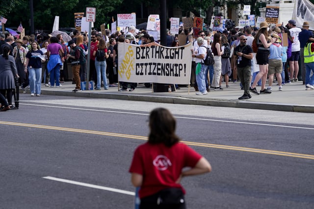 People protest on the day the Supreme Court justices hear oral arguments over U.S. President Donald Trump's bid to broadly enforce his executive order to restrict automatic birthright citizenship, outside the U.S. Supreme Court in Washington, D.C., U.S., May 15, 2025. REUTERS/Nathan Howard/File Photo