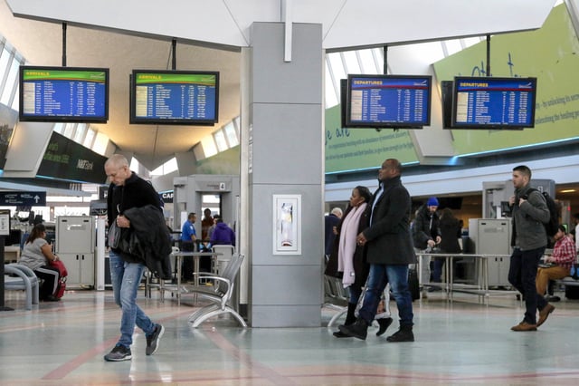 Travelers walk through the terminal at the Buffalo Niagara International Airport on Monday, Dec. 10, 2018.