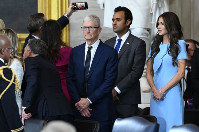 Apple CEO Tim Cook stands in the middle of a group of people at the inauguration of Donald Trump on Jan. 20, 2025, in Washington, DC.