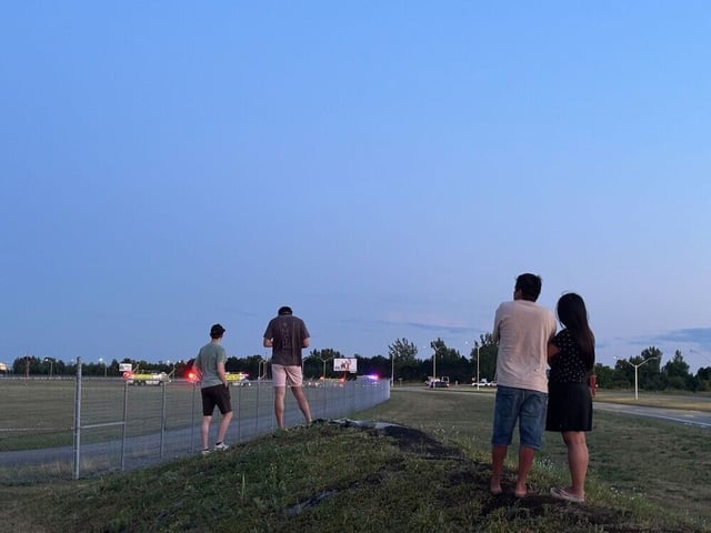  On-lookers near the scene of a small plane crash close to the Ottawa airport on the evening of Thursday, July 31, 2025.