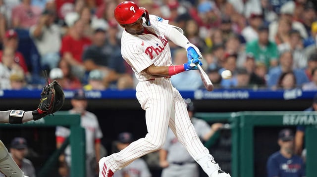 Jul 23, 2025; Philadelphia, Pennsylvania, USA; Philadelphia Phillies outfielder Johan Rojas (23) hits an RBI single against the Boston Red Sox in the eleventh inning at Citizens Bank Park. Mandatory Credit: Kyle Ross-Imagn Images