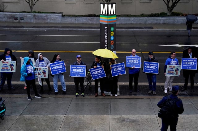 Labor union members hold placards on the day of a rally in support of federal workers during a rush hour protest outside the L'Enfant Plaza Metro Station in Washington, D.C., U.S., March 24, 2025. REUTERS/Kent Nishimura/File Photo