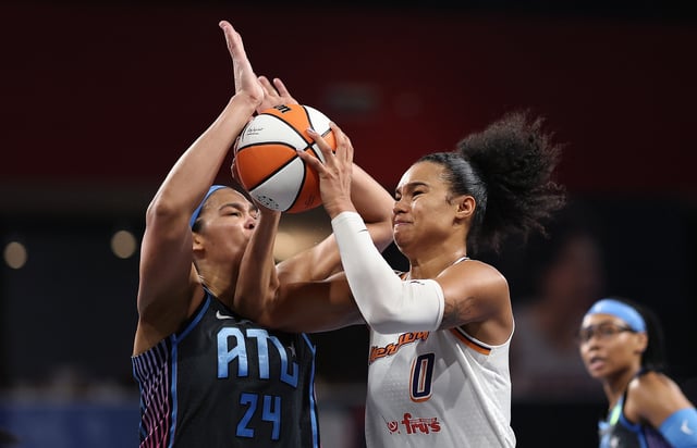 Satou Sabally #0 of the Phoenix Mercury drives against Brionna Jones #24 of the Atlanta Dream during the second quarter at Gateway Center Arena on August 01, 2025 in College Park, Georgia.