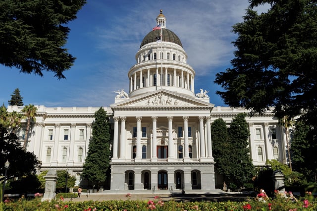 People walk around the California State Capitol on Monday, Aug. 5, 2024, in Sacramento, Calif. California will see a new minimum wage on Jan. 1, 2026.