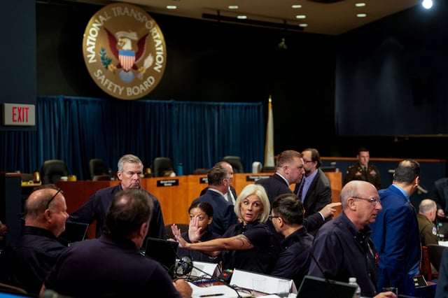 National Transportation Safety Board (NTSB) Chairwoman Jennifer Homendy talks with staff during a brief intermission in day three of a National Transportation Safety Board (NTSB) investigative hearing on the January 29 mid-air collision of an Army Sikorsky UH-60L Black Hawk helicopter and American Airlines flight 5342 over the Potomac River near Ronald Reagan Washington National Airport, at NTSB headquarters in Washington, D.C., U.S., August 1, 2025. REUTERS/Kent Nishimura