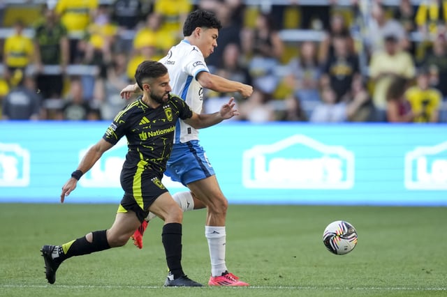 Aug 1, 2025; Columbus, Ohio, USA; Puebla defender Luis Gabriel Rey (3) battles for the ball against Columbus Crew forward Diego Rossi (10) in the first half at Lower.com Field. Mandatory Credit: Aaron Doster-Imagn Images