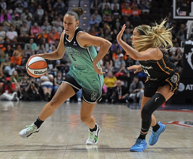 Stephanie Talbot of the Liberty tries to drive past Sun defender Jacy Sheldon during a WNBA game on Friday night at Mohegan Sun Arena. Sheldon and the Sun stunned the defending champs with a 78-62 win. (Sean D. Elliot/Getty Images)