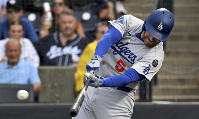 The Dodgers’ Freddie Freeman hits a two-run double during the first inning of their game against the Tampa Bay Rays on Friday night in Tampa, Fla. (AP Photo/Jason Behnken)