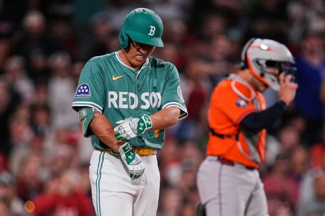 Boston Red Sox designated hitter Masataka Yoshida reacts after getting hit by a pitch during the seventh inning of a baseball game against the Houston Astros at Fenway Park, Friday, Aug. 1, 2025, in Boston. (AP Photo/Charles Krupa)