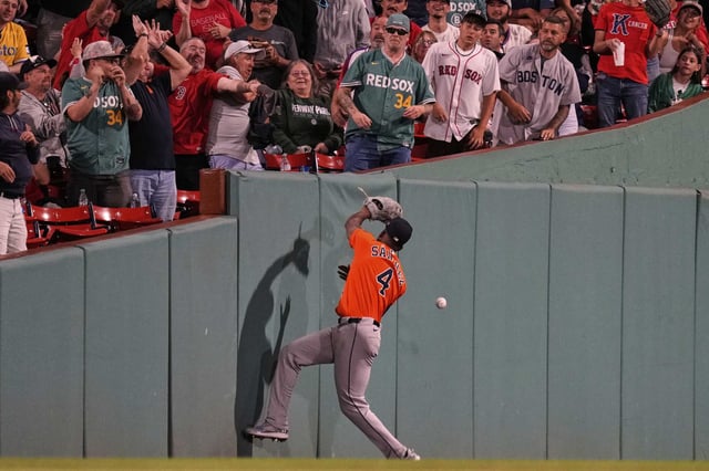 Houston Astros outfielder Jesus Sanchez (4) misses a catch on a foul ball hit  by Boston Red Sox designated hitter Masataka Yoshida during the seventh inning of a baseball game at Fenway Park, Friday, Aug. 1, 2025, in Boston. (AP Photo/Charles Krupa)
