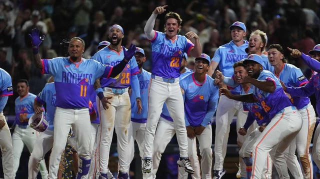 Aug 1, 2025; Denver, Colorado, USA; Members of the Colorado Rockies celebrate center fielder Brenton Doyle (9) (not pictured) two run walk off home run in the ninth inning against the Pittsburgh Pirates at Coors Field. Mandatory Credit: Ron Chenoy-Imagn Images