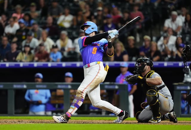 Aug 1, 2025; Denver, Colorado, USA; Colorado Rockies center fielder Brenton Doyle (9) hits a two run walk off home run in the ninth inning against the Pittsburgh Pirates at Coors Field. Mandatory Credit: Ron Chenoy-Imagn Images