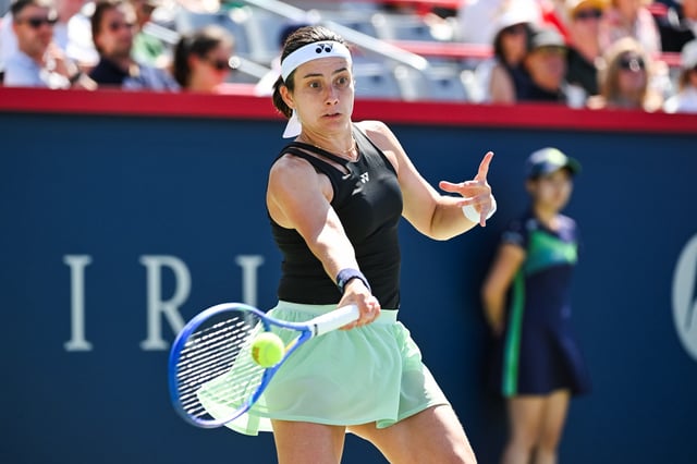 Aug 1, 2025; Montreal, QC, Canada; Anastasija Sevastova (LAT) returns the ball to Jessica Pegula (USA) in third round play at IGA Stadium. Mandatory Credit: David Kirouac-Imagn Images